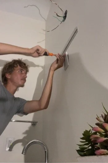 Light of the World electrician wiring a new bathroom fixture